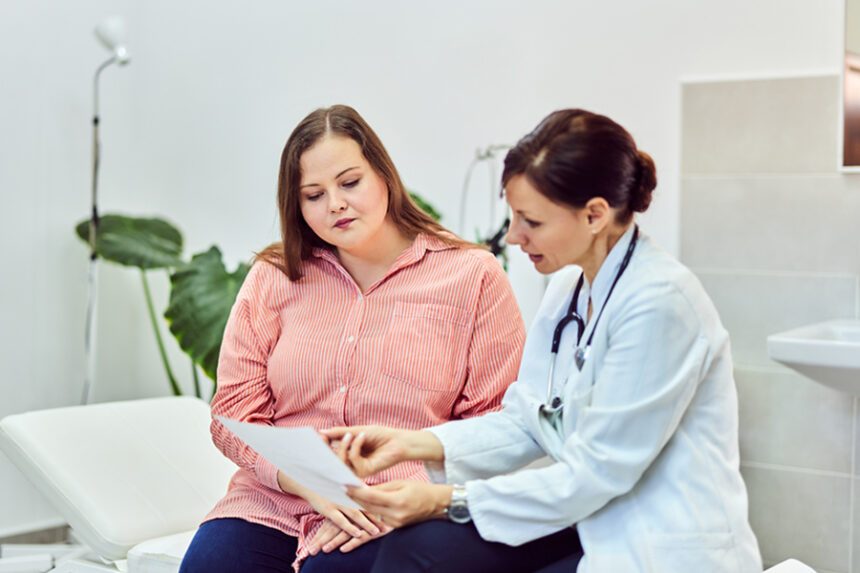 woman sits with provider, discussing test results