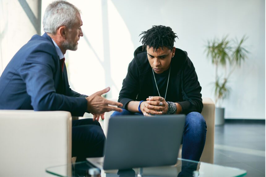 A therapist talking with a young man who looks concerned.