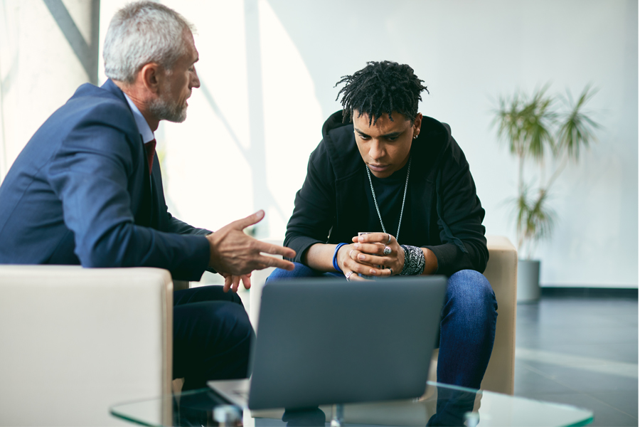 A therapist talking with a young man who looks concerned.