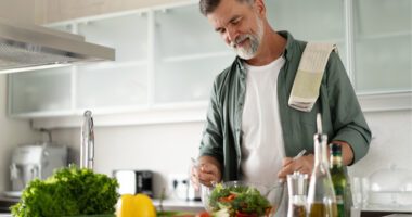 A man preparing healthy food in the kitchen.