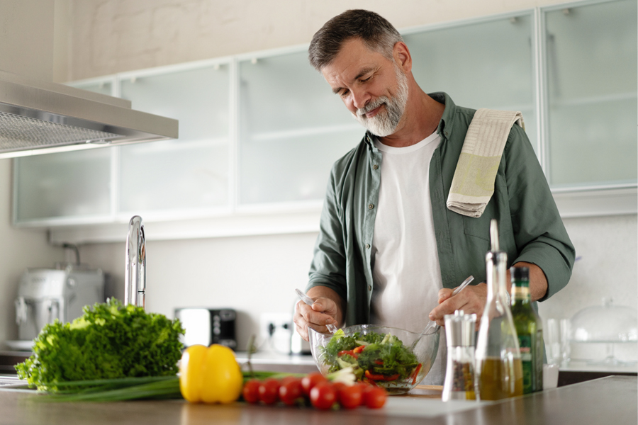 A man preparing healthy food in the kitchen.