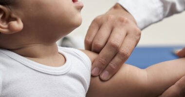 provider feels a baby's shoulder