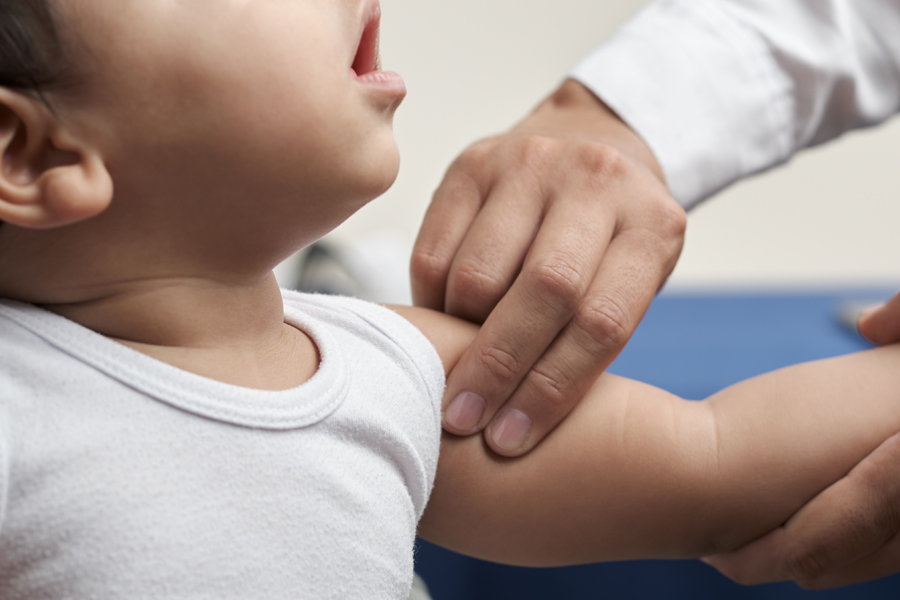 provider feels a baby's shoulder