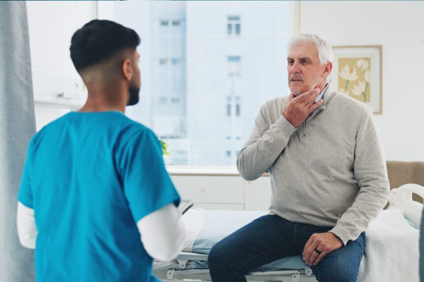 An older adult receives a throat evaluation from a healthcare provider.