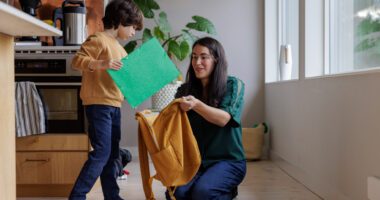 Mom helping her son get ready to go back to school.