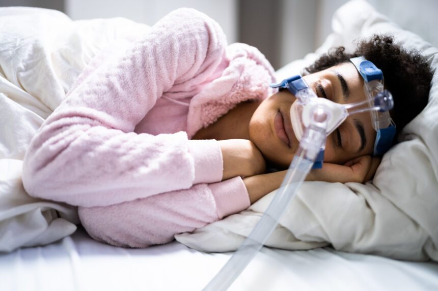 woman sleeps with CPAP machine over her face