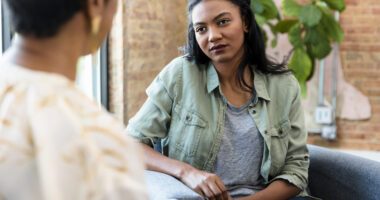 Two women having a conversation during a mental health counseling session.