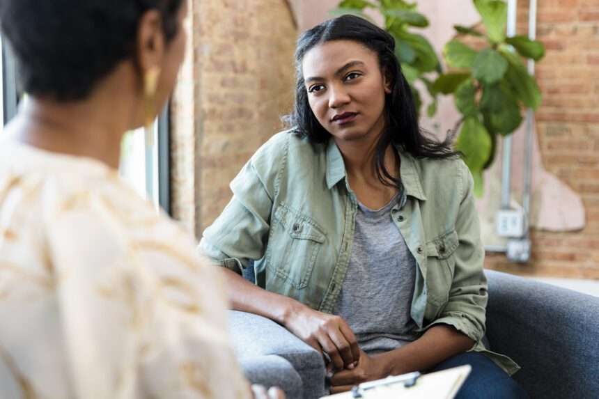 Two women having a conversation during a mental health counseling session.
