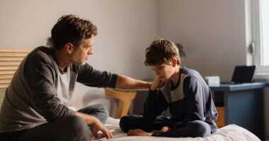 An adult talking with a young person.