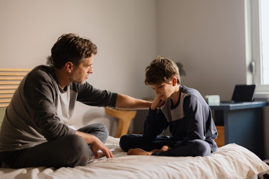 An adult talking with a young person.