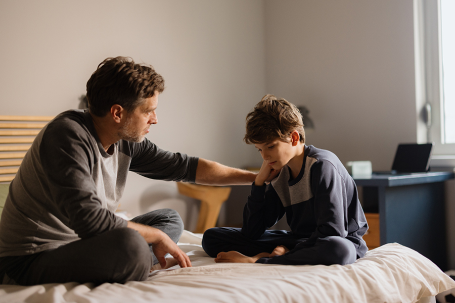 An adult talking with a young person.
