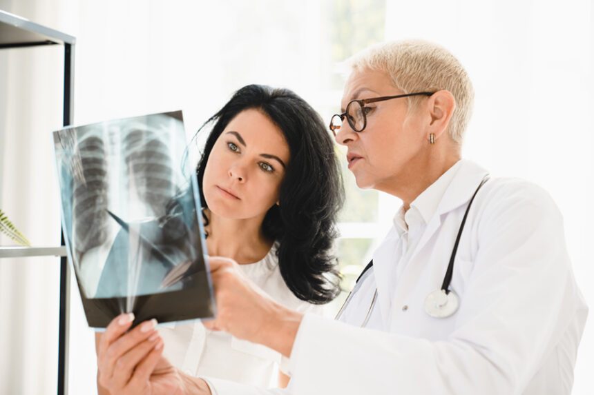 Doctor explaining a lung X-ray to a patient.